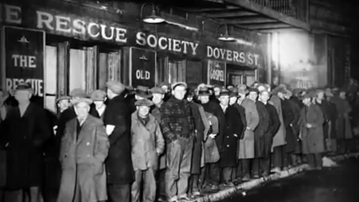 Historical black and white photo of men in a breadline, symbolizing economic hardship.