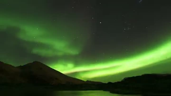 Stunning display of the Aurora Borealis illuminating the Alaskan night sky.