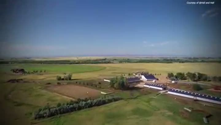 A vast, open landscape with a solitary farm, showcasing the luxury of space.