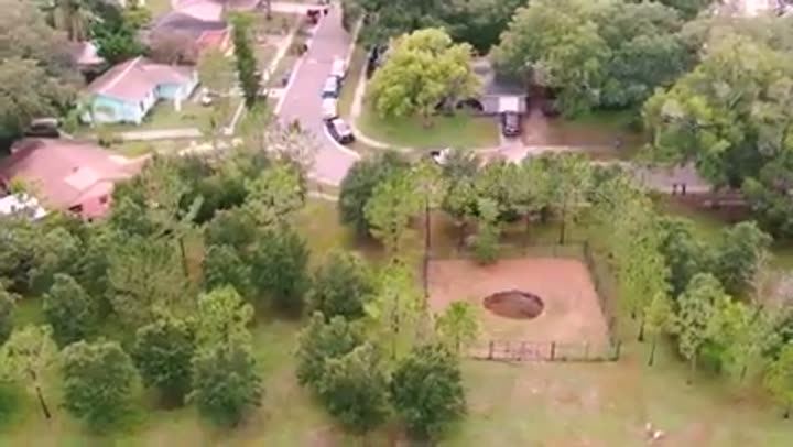 A large sinkhole opens up in a residential area, revealing Florida's unstable subsurface.