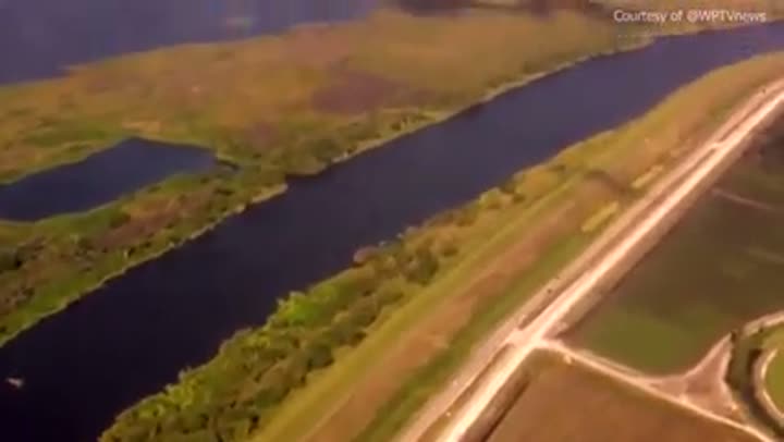Aerial view of canals and agricultural fields, showing the drained Everglades landscape.