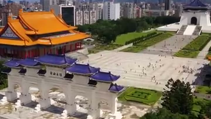 Grand architectural complex in a bustling Asian city, symbolizing innovation.