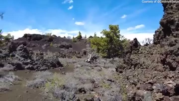 Rugged lava fields and sparse vegetation showcase Idaho's volcanic heartland geology.